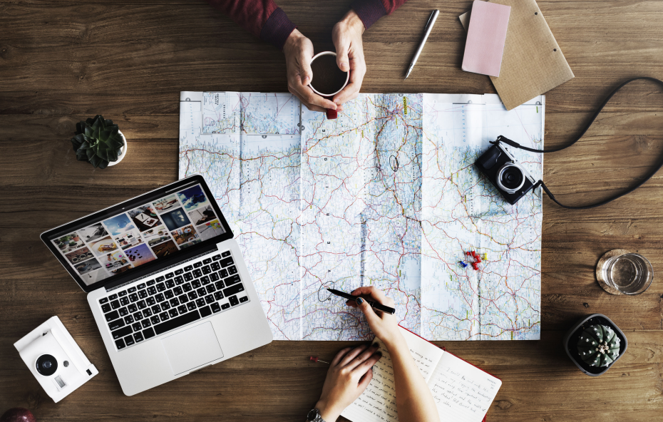 a group of people sitting at a table with a map to prepare for a ski tour